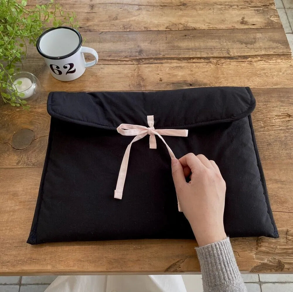 Black and white quilted nylon laptop bag for women with a ballet bow and striped pattern.