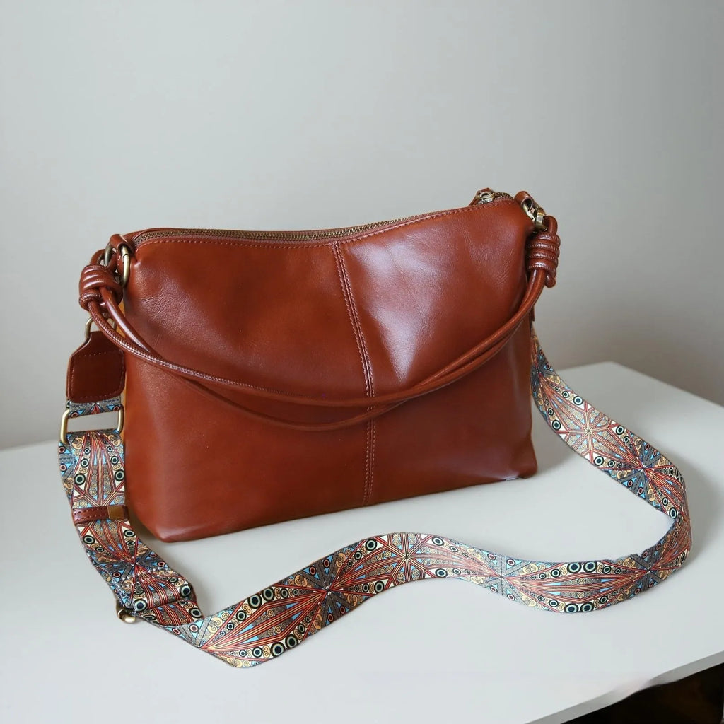 Genuine leather creative large capacity hand and shoulder commuter bag in caramel colour with pillow shape and patchwork details