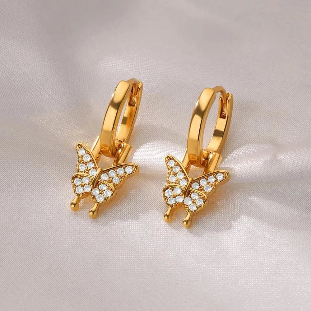 Women's copper butterfly earrings with geometric heart, star, and bow shapes and cubic zirconia stones.