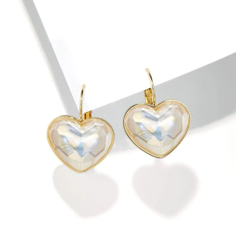 Gold coloured women's clip-on earring made from alloy with metal design details.
