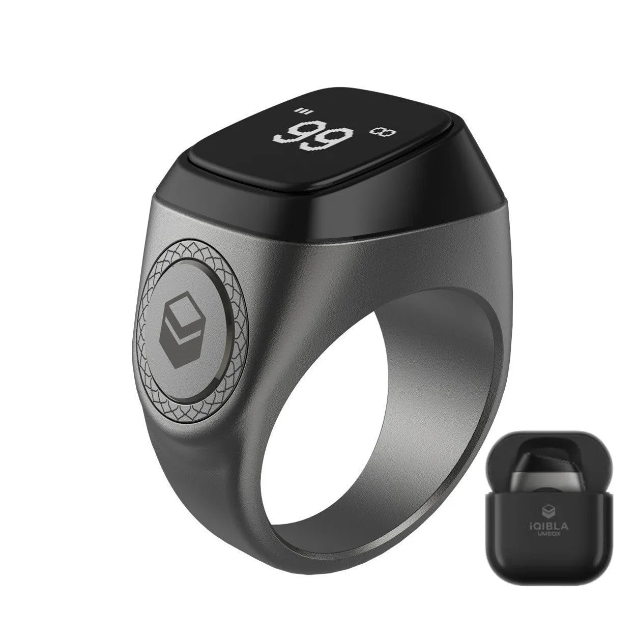 Zikr1 smart ring in silver on a charging cable next to its case, showing the OLED display.