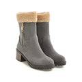A pair of snow boots in black, shown with a soft plush lining and rubber insole.