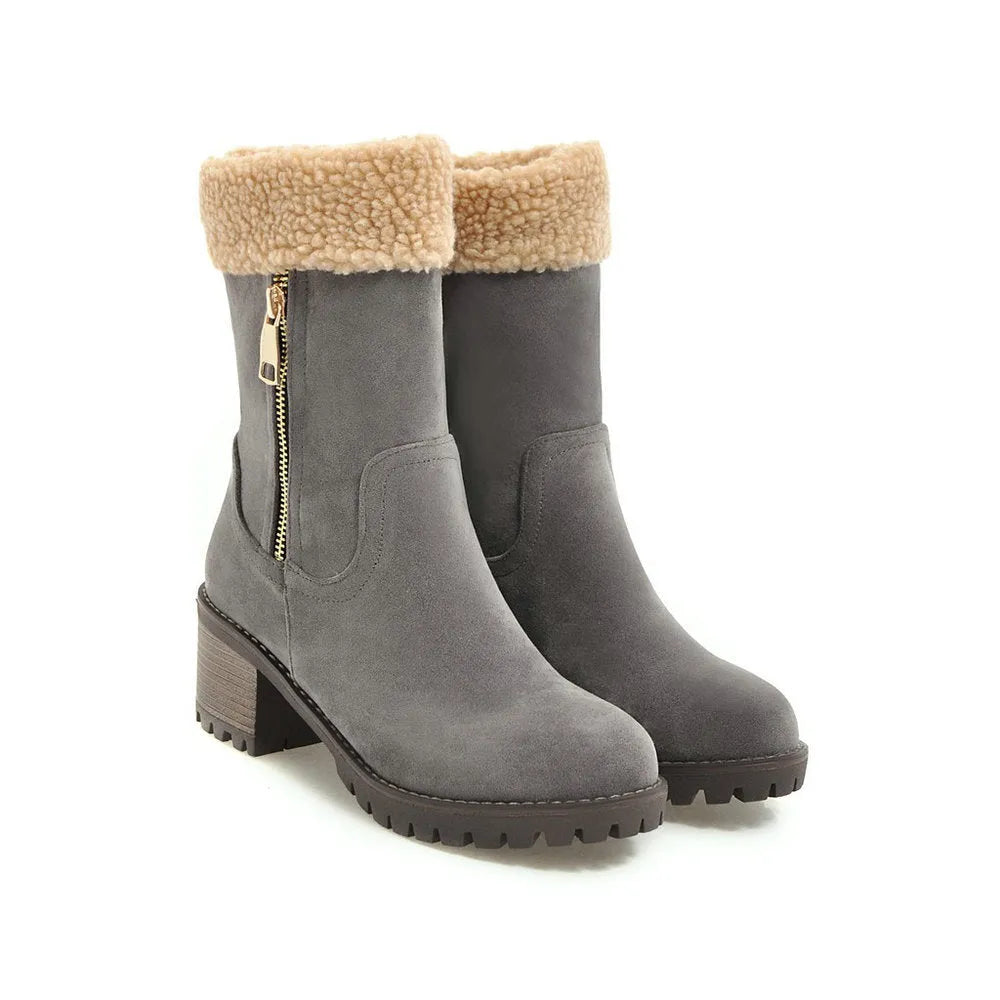A pair of snow boots in black, shown with a soft plush lining and rubber insole.