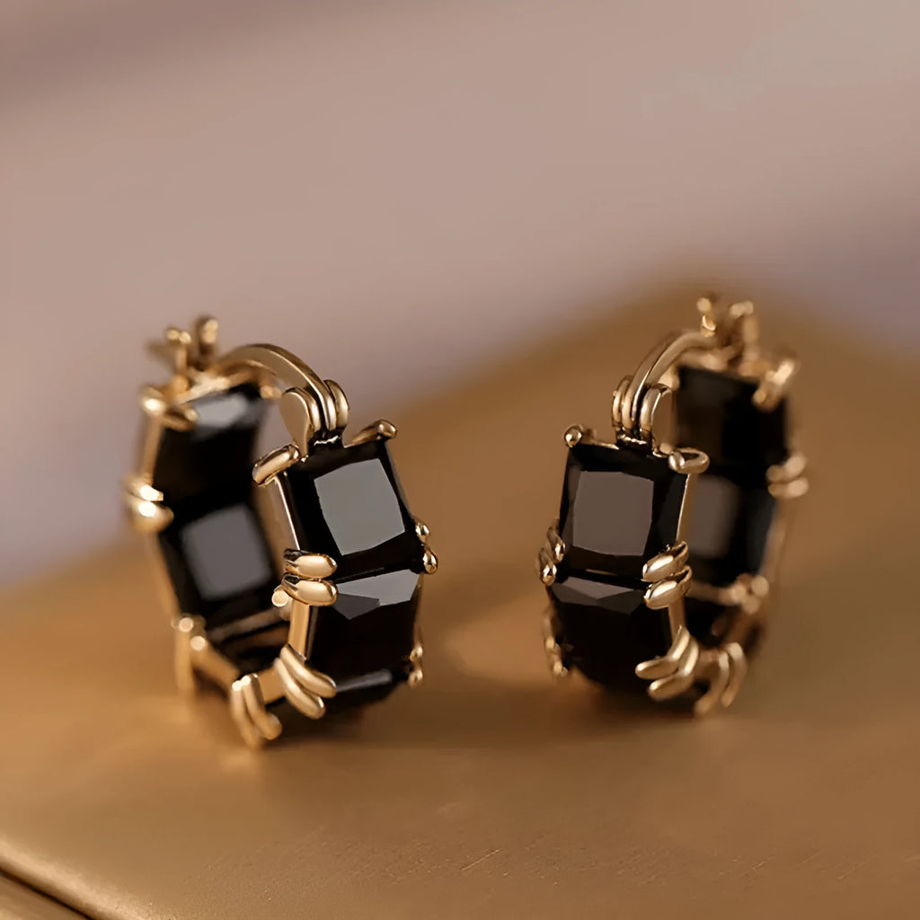 Geometric U-shaped earrings with round crystal zirconium stones in gold setting