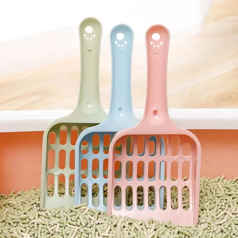 Blue plastic cat litter scoop showing its size on a white background.