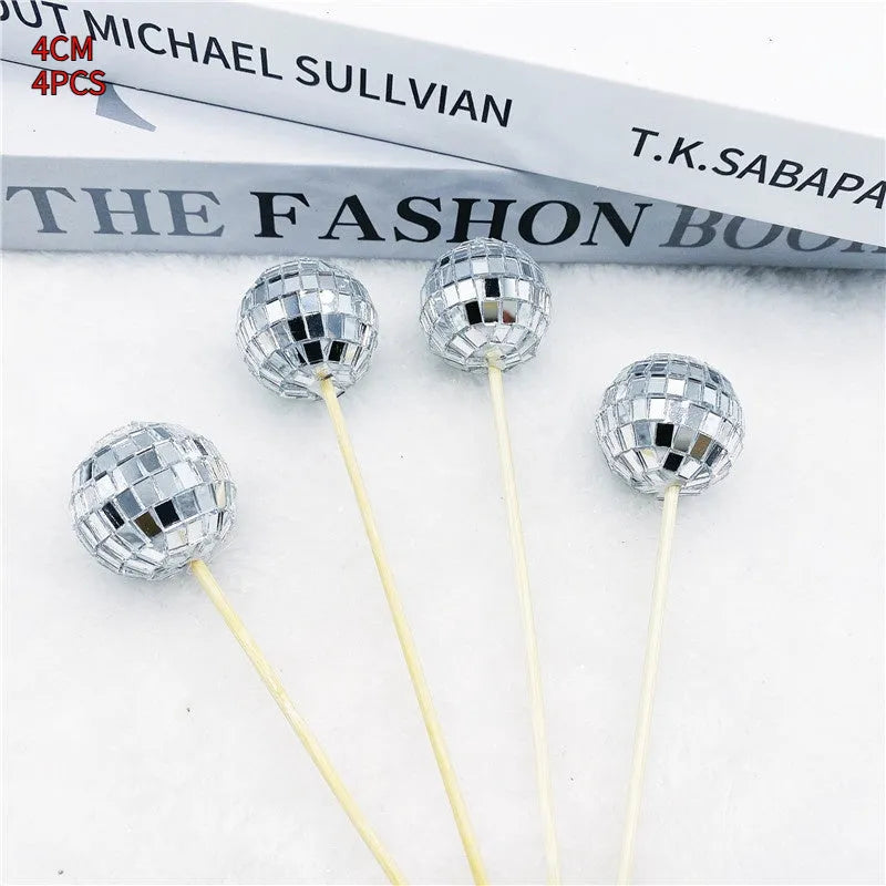 Glass disco ball cake decoration with wooden stick on a birthday cake