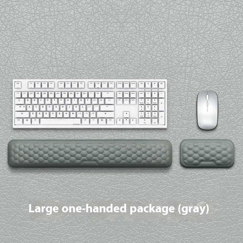 Grey and black memory cotton mouse wrist pads in cloth and leather styles on a desk.