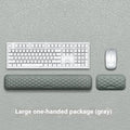 Grey and black memory cotton mouse wrist pads in cloth and leather styles on a desk.