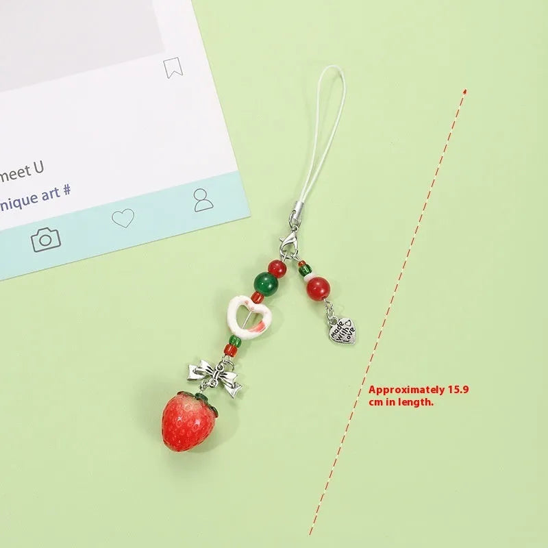 Cute fruit design mobile phone charm keychain in plastic resin with apple or strawberry motif.