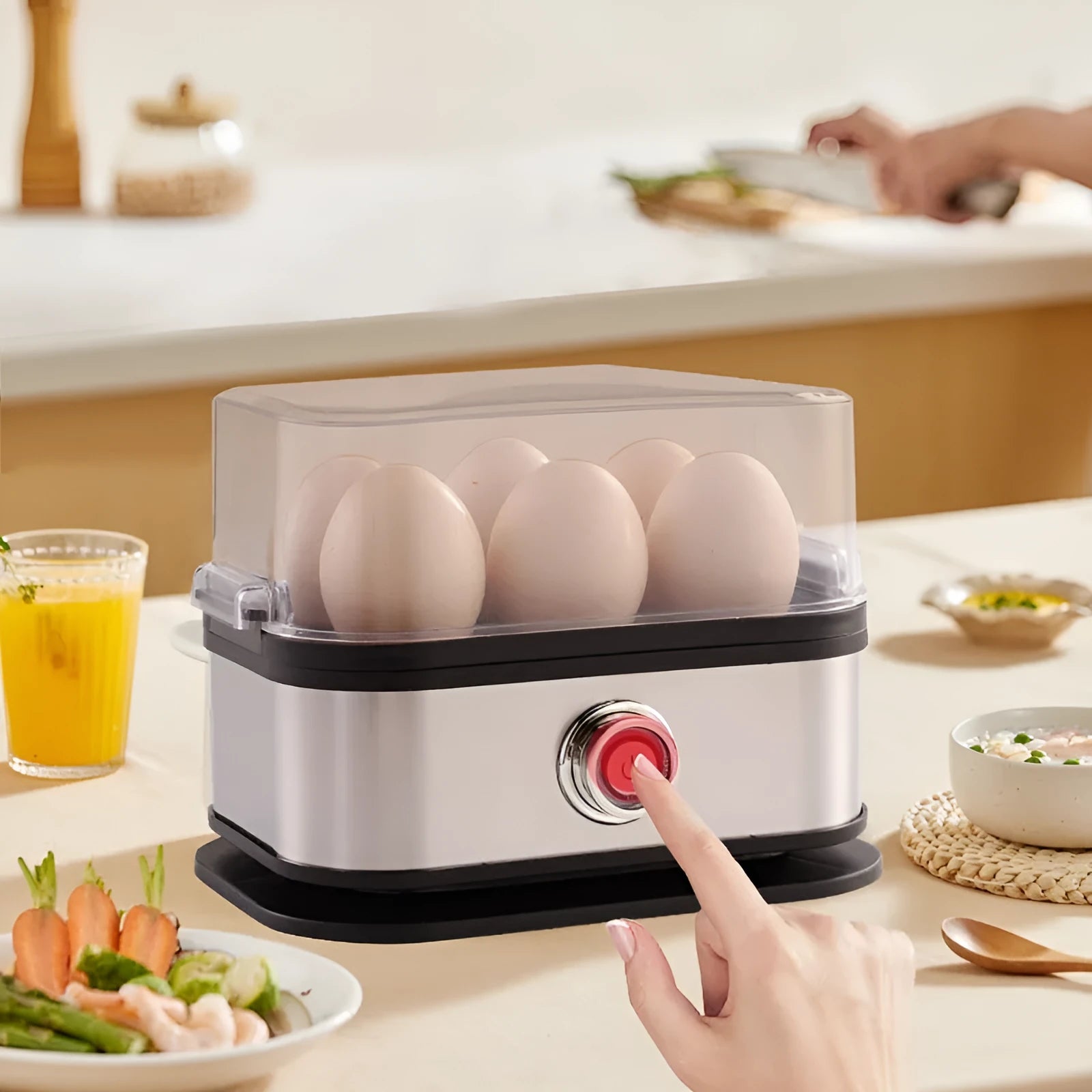 Black stainless steel portable egg boiler with a carry belt.