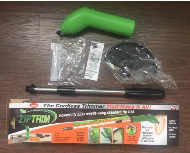 Cordless Zip Trim lawn trimmer with extension pole and protective shield on garden grass