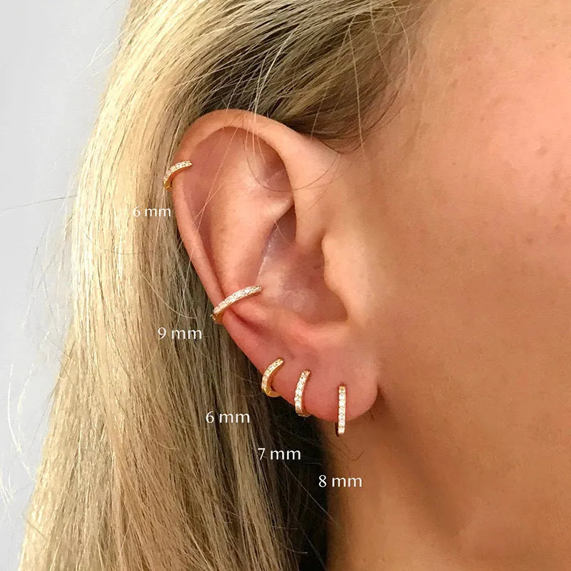 Perforated circle zircon stud earrings in gold colour with geometric pattern and butterfly clasp