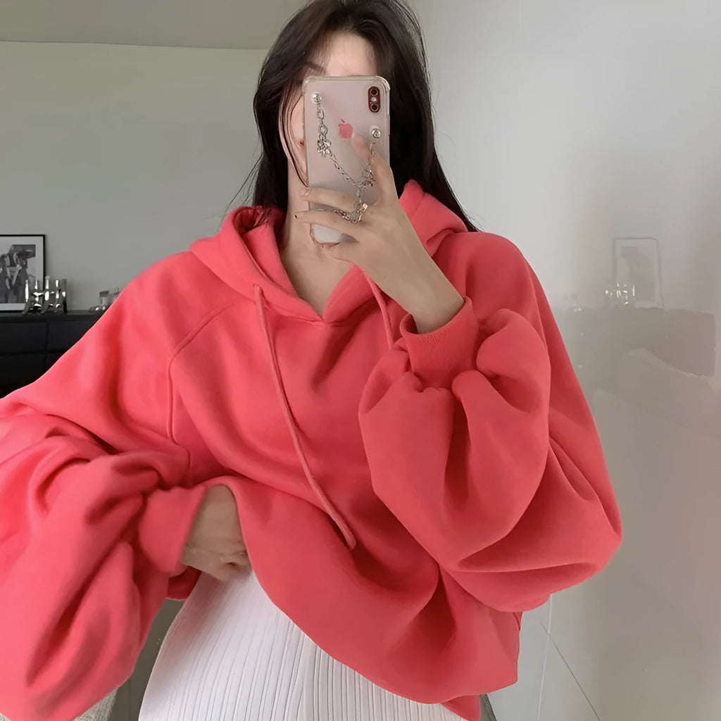 Women's loose watermelon red hooded sweater made from Mulberry Silk, shown on a hanger.