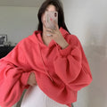 Women's loose watermelon red hooded sweater made from Mulberry Silk, shown on a hanger.