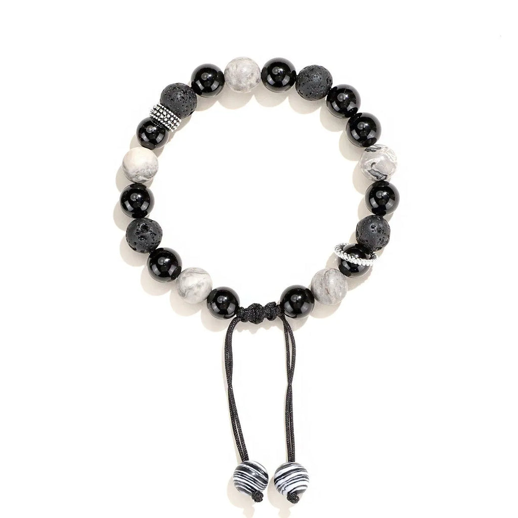Black agate map stone diamond-shaped volcanic rock bracelet on a wrist, showing New Chinese style.