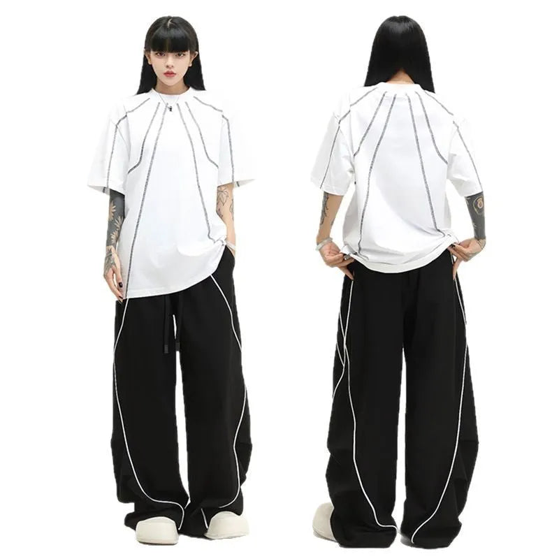 Black pleated wide-leg trousers with stripe pattern showing loose fit and mid waist design