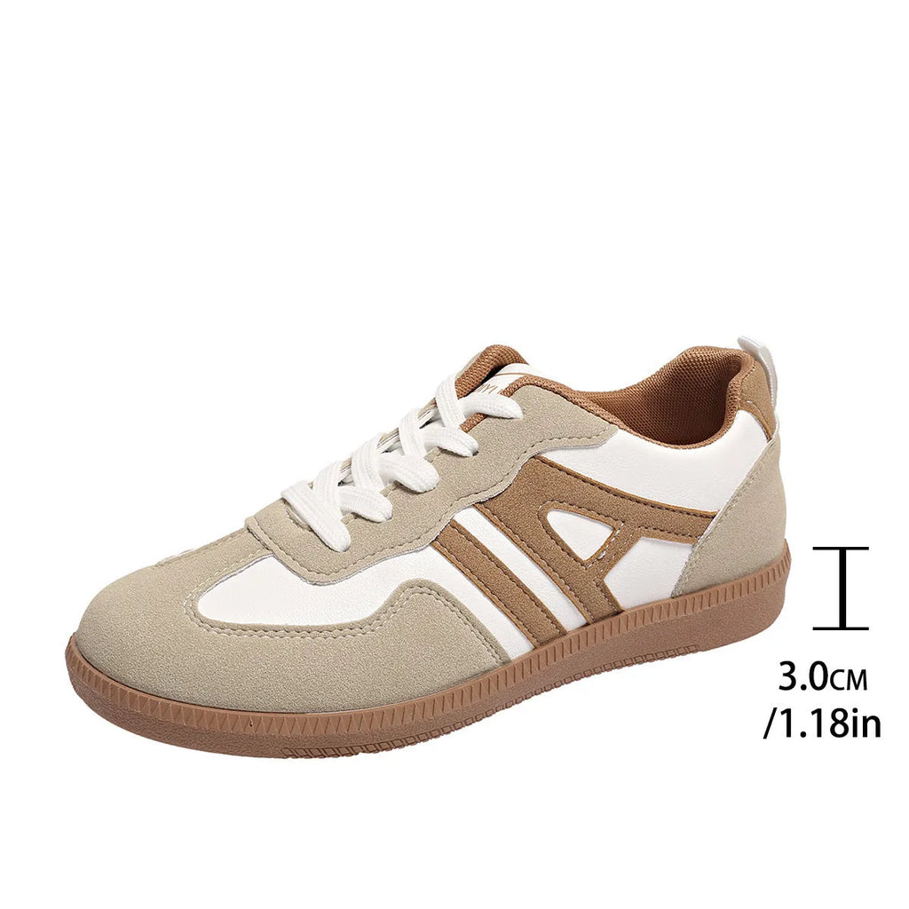Women's retro style lace-up jogging shoes in grey with a cross strap and low platform heel.