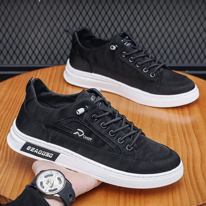 Grey men's low-top canvas casual shoes with a round toe and white rubber sole on a plain background.