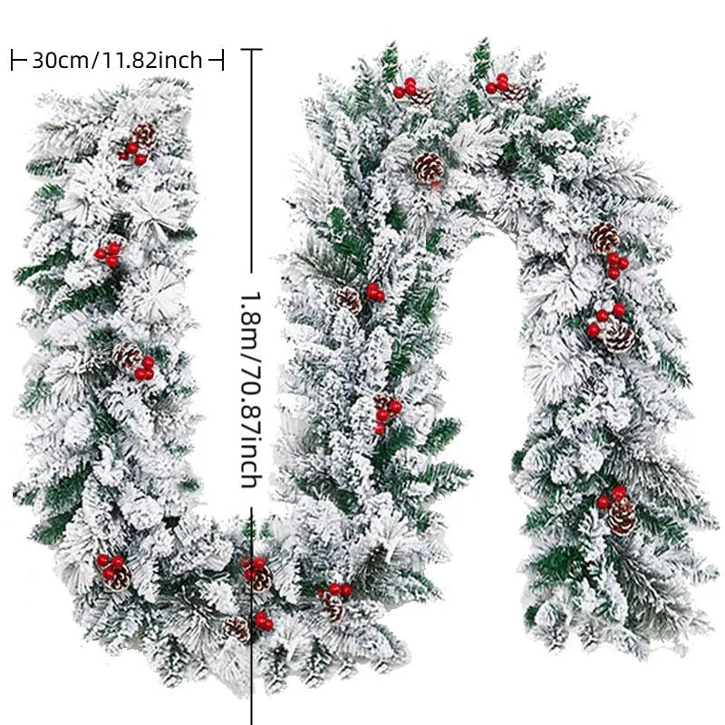 Snow-flocked artificial rattan Christmas garland in green and white on a wooden mantelpiece.
