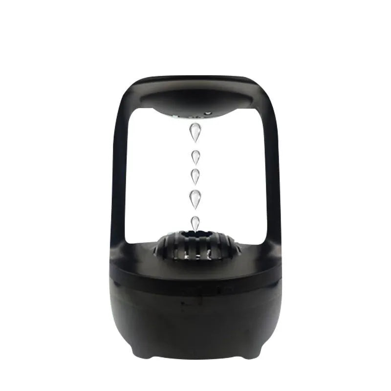 White anti-gravity humidifier on a table showing floating water droplets above its tank.