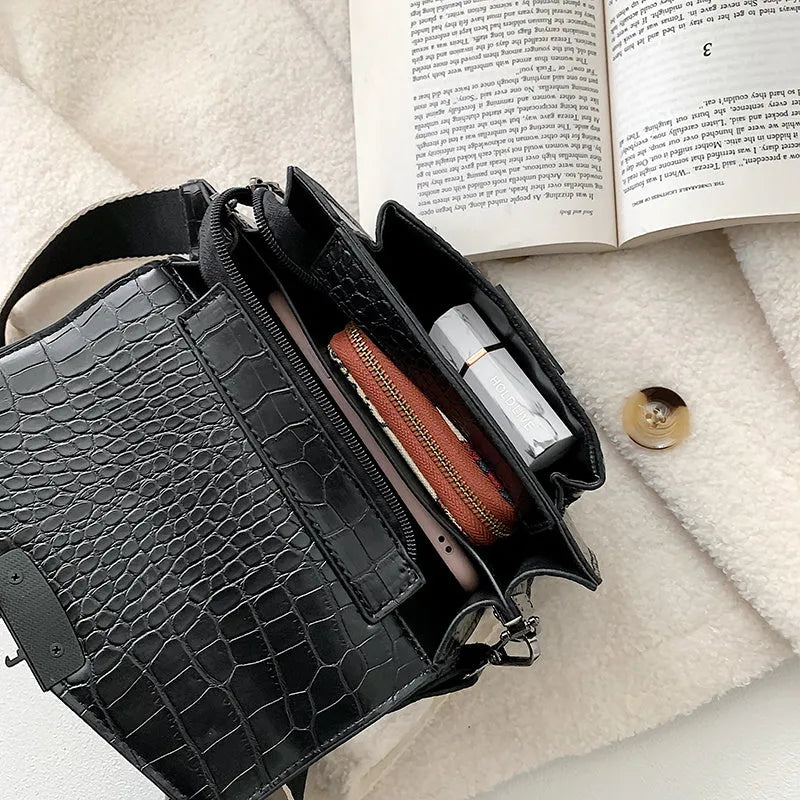 Vintage PU leather crossbody bag in black, shown with adjustable strap.