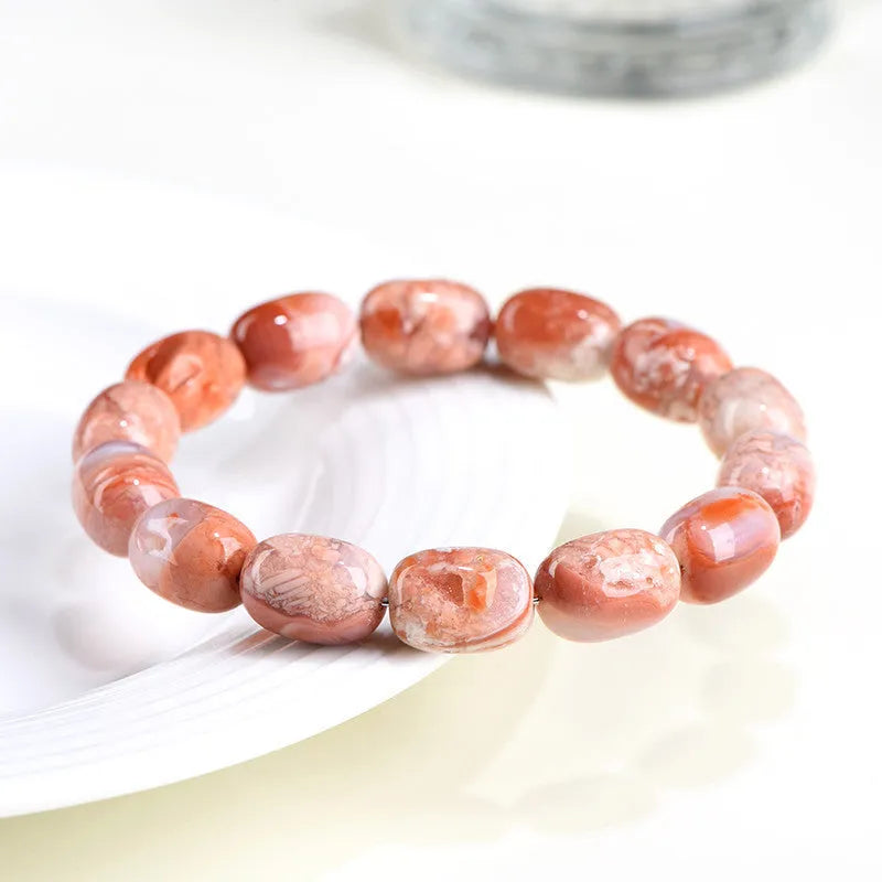 Natural cherry agate bracelet with geometric barrel beads and a Ruyi design detail.
