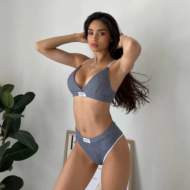 Women's embroidered black bikini set with contrast binding and shorts-length bottoms.