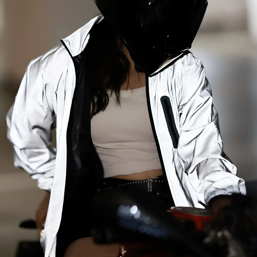 Silver waterproof polyester long sleeved work top laid flat, showing long sleeves and front zip.