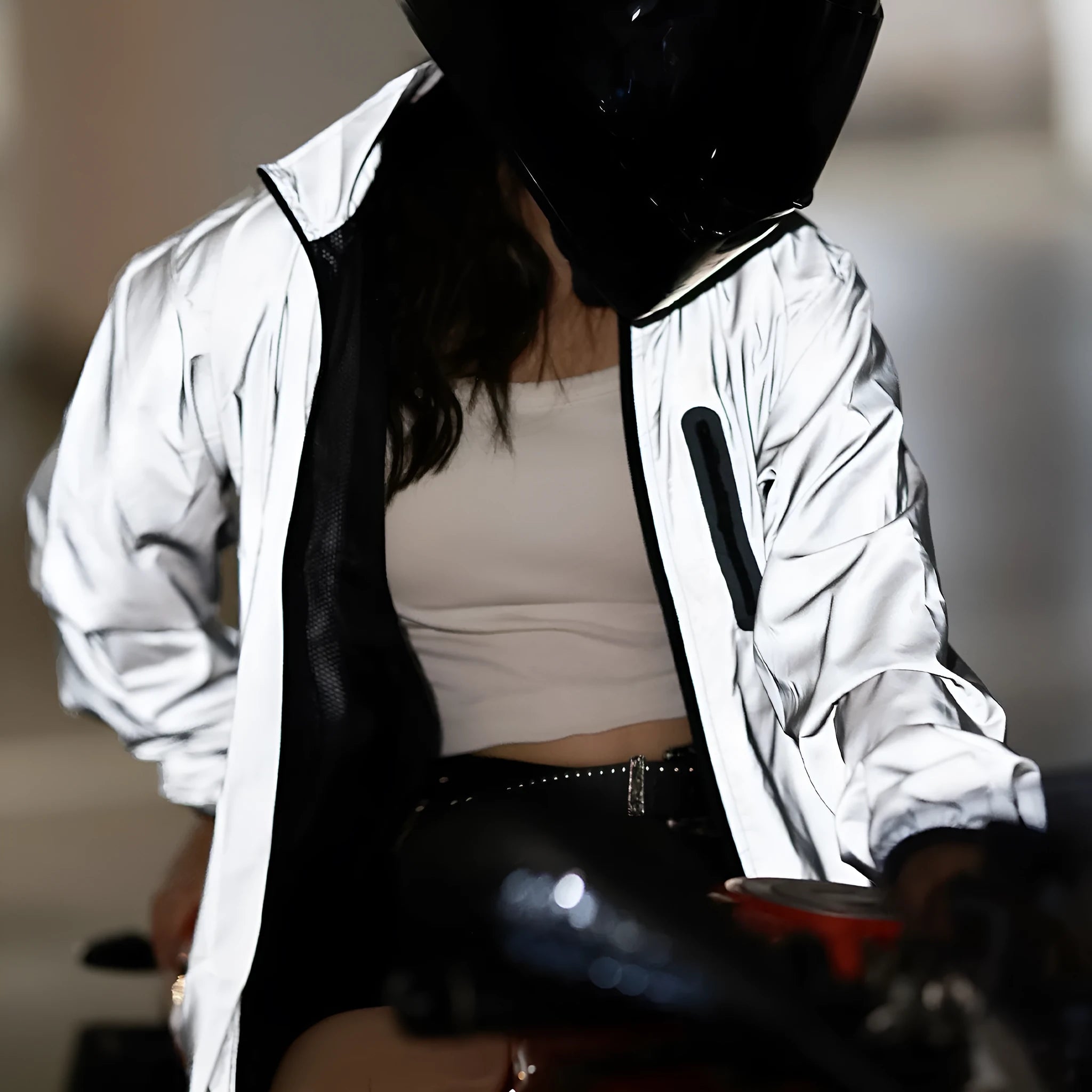 Silver waterproof polyester long sleeved work top laid flat, showing long sleeves and front zip.