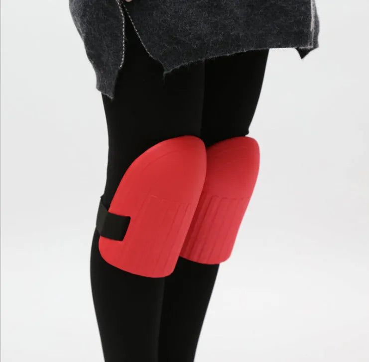 A pair of black EVA foam knee pads showing their rectangular shape and thick profile for knee protection.