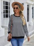 Black polyester pullover sweater with a plaid printed pattern and long sleeves.