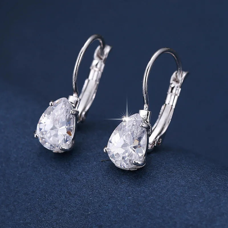 Women's drop-shaped copper earrings with a gemstone inlay, available in gold or platinum colour finish.