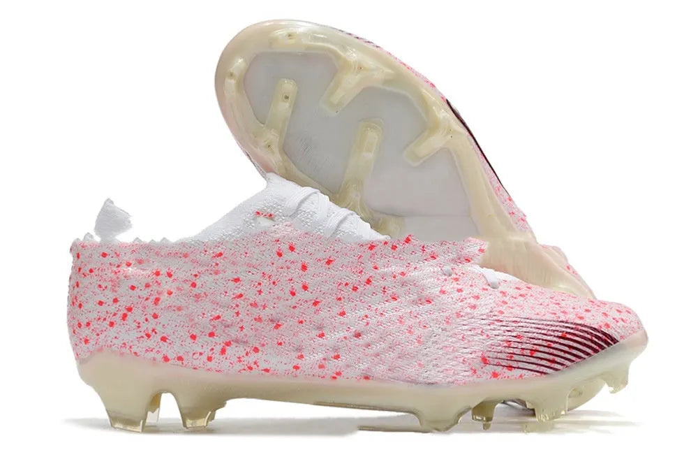 Men's low-top football shoes with knitted upper, lace-up front, and FG studs on rubber outsole.