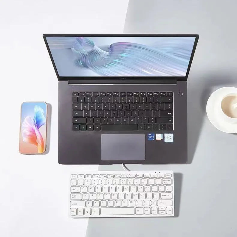 Compact wired USB keyboard in four colour options: black, white, pink, and blue