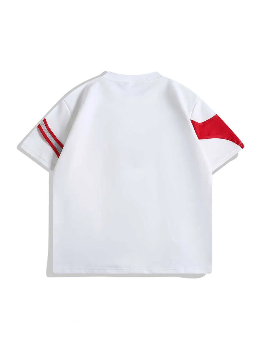 Loose black t-shirt showing double stitching detail forming a padded strap over the shoulder