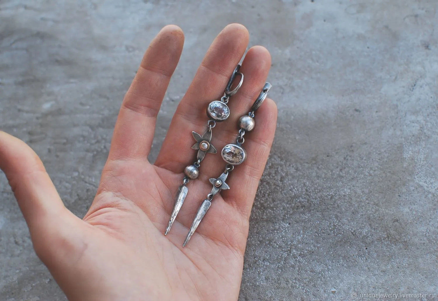 Geometric long pendant earrings in antique silver with rhinestone details on a stud.