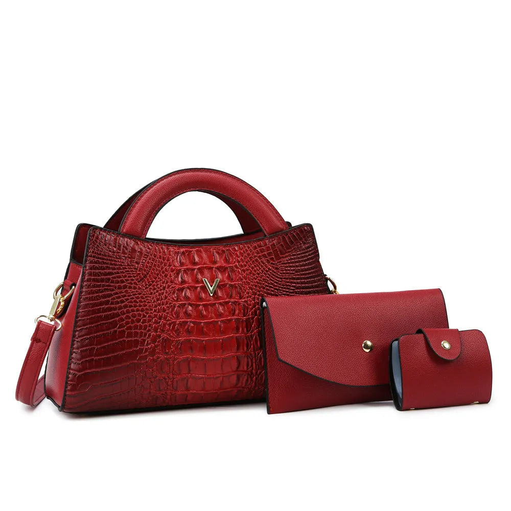 Women's square black crossbody handbag with crocodile pattern texture, showing front zip and adjustable strap.