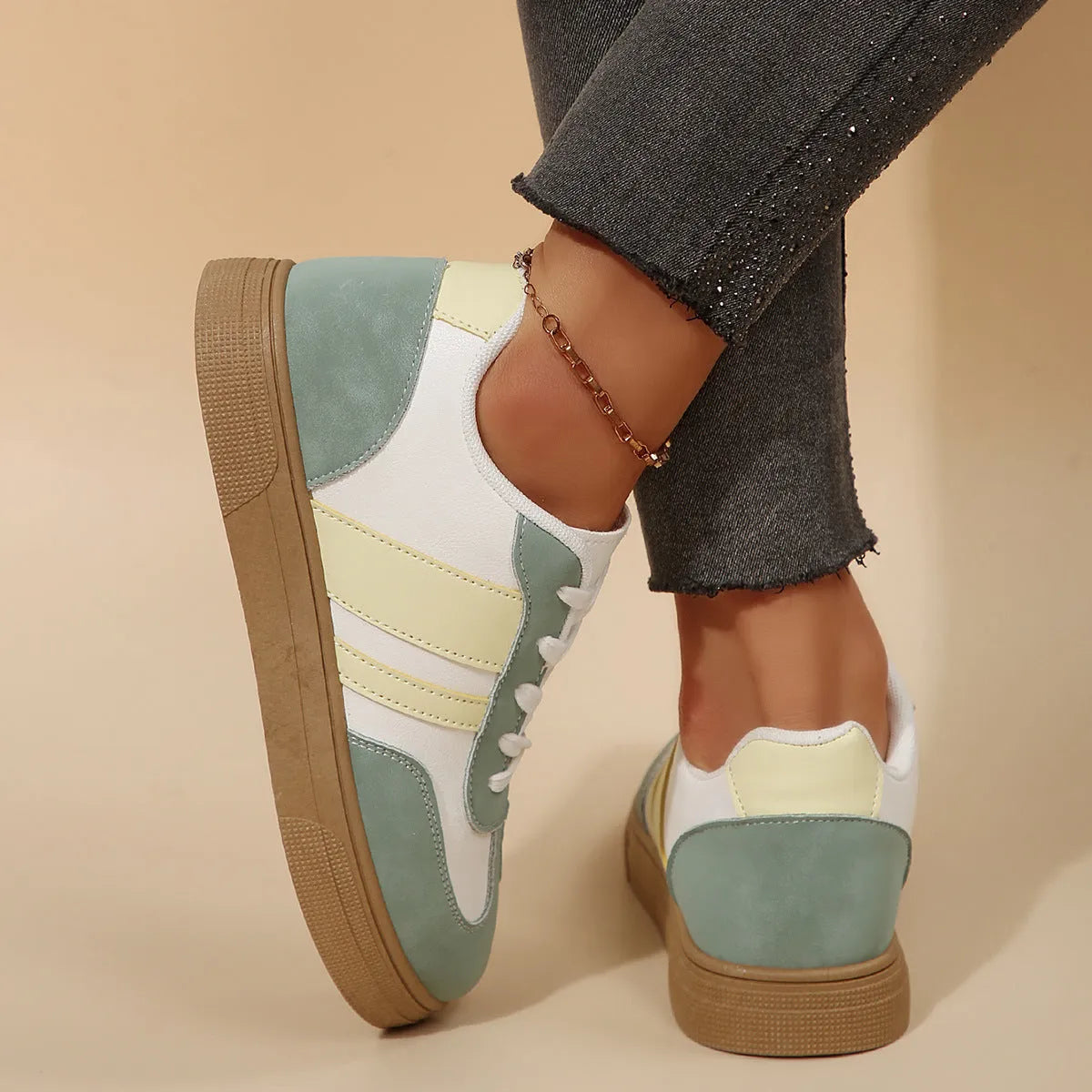 Green women's retro sports shoes with white cross straps and a low flat heel