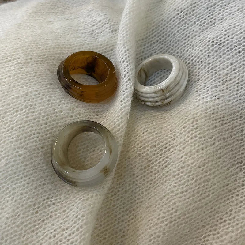 Resin ring with irregular geometric wide band design in brown and white colour options