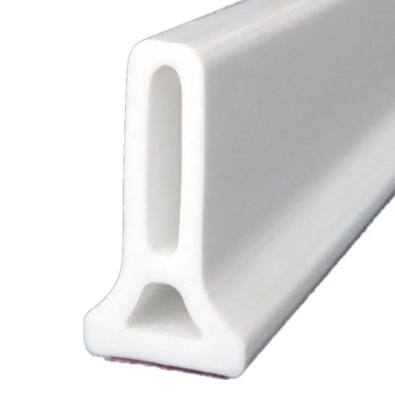 Flexible TPE bathroom water blocking strip in black on white tile floor
