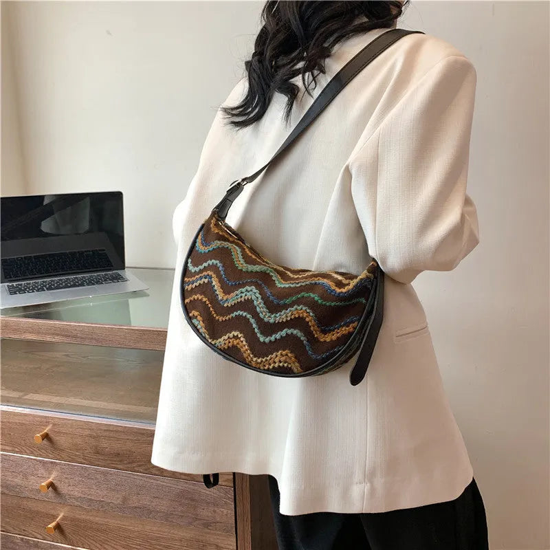 Women's straw woven crossbody bag showing woven texture and internal organisation with phone pocket