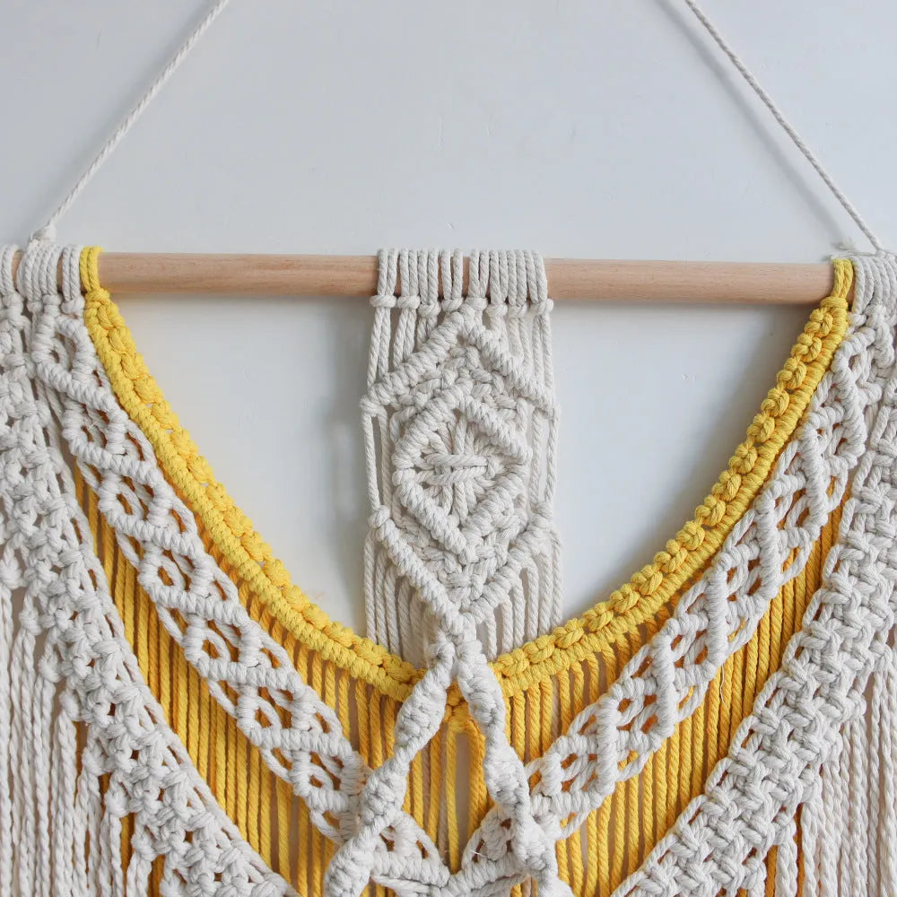 Creamy white hand-woven cotton Nordic tapestry hanging on a wall, 120cm wide by 95cm high.