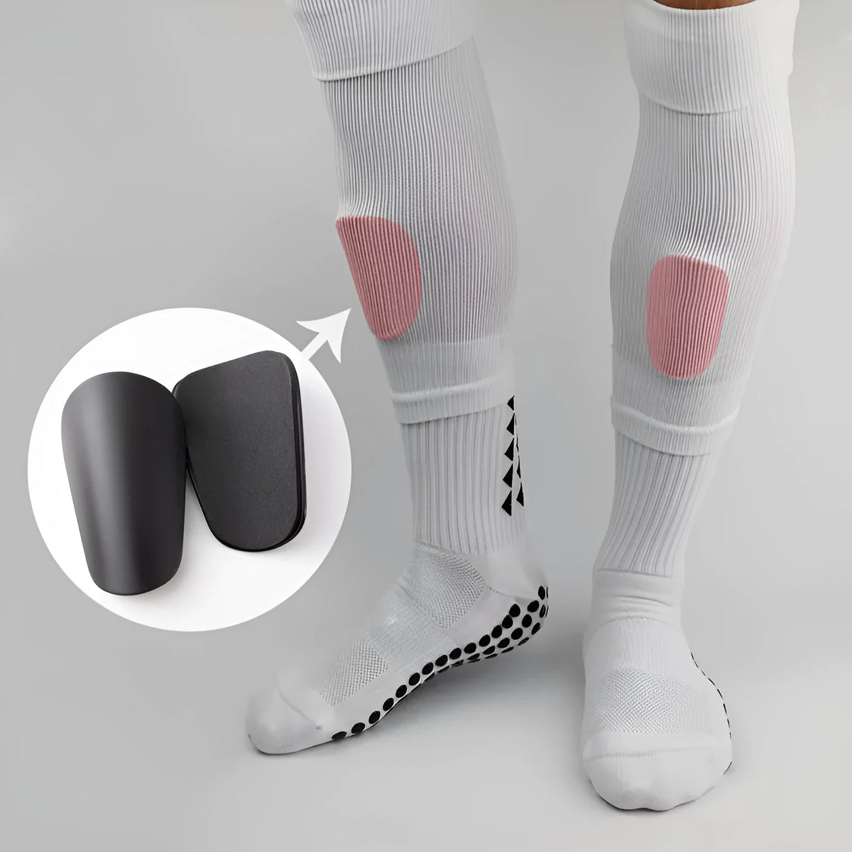 Pair of PU mini shin guards for sports protection in black, shown on a leg.