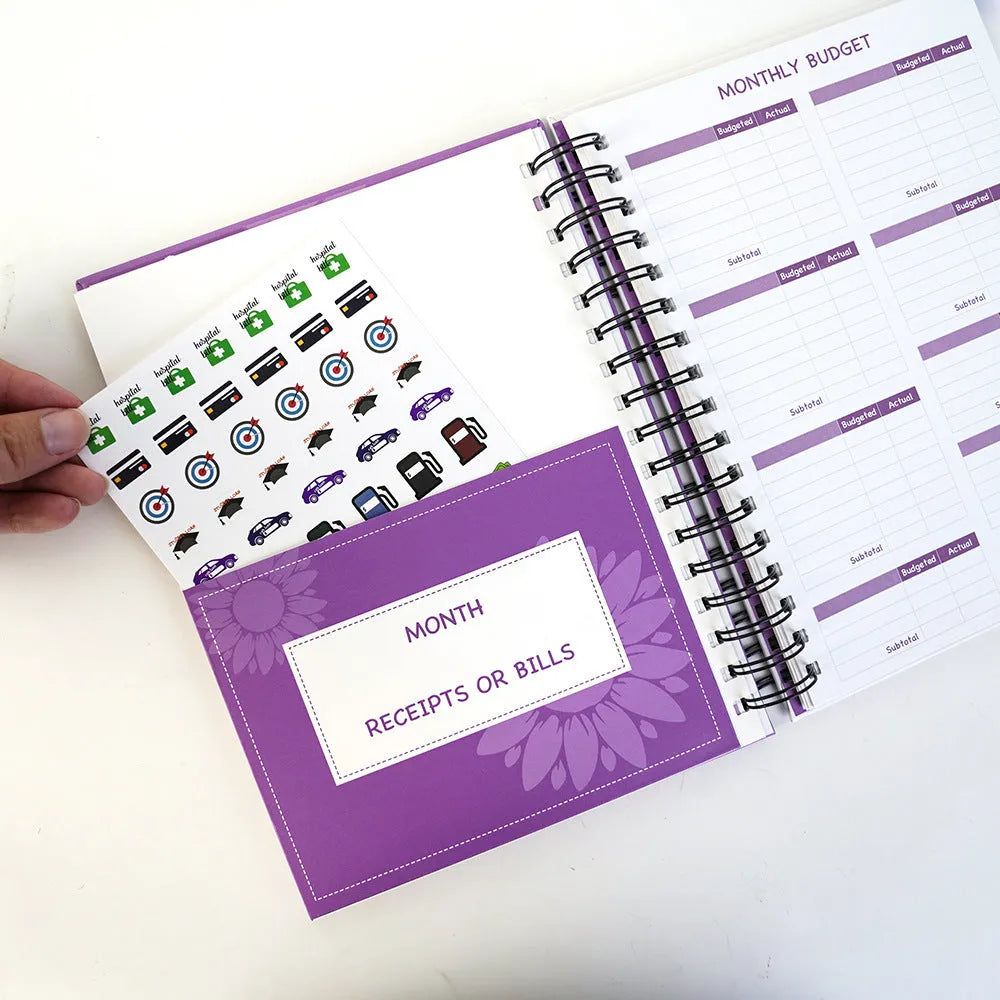 J12 Purple coil-bound financial planning notebook with Daolin paper, pen, stickers, and paper clips for monthly budgeting