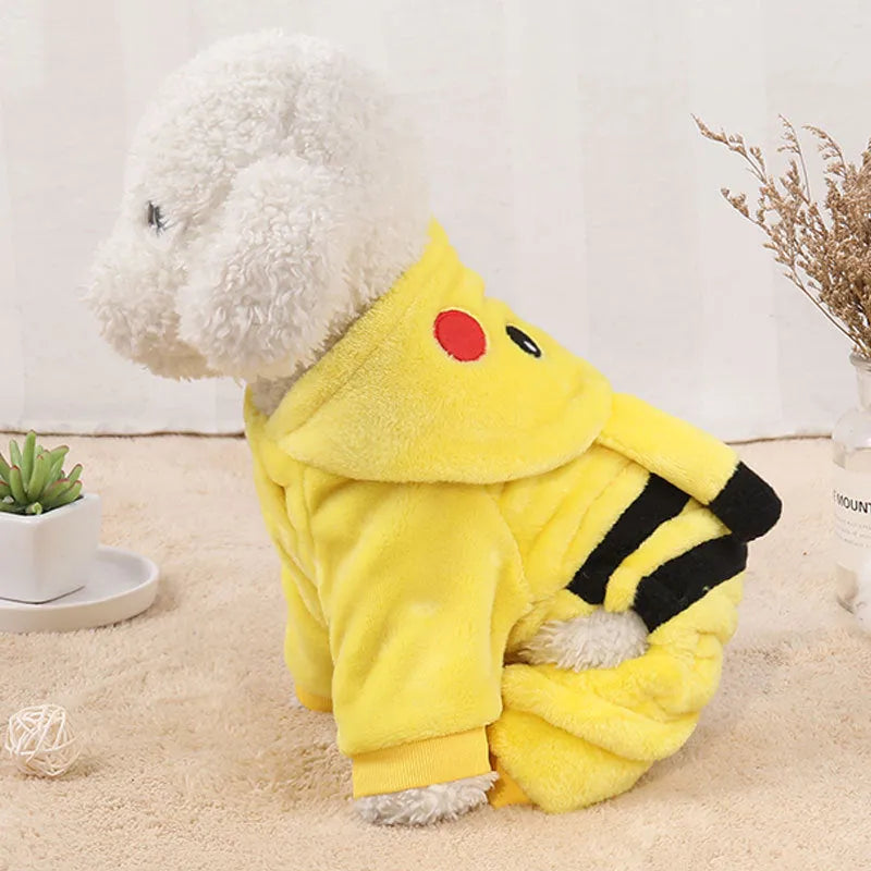 A small cat or dog wearing a cosy grey fleece hoodie coat indoors.