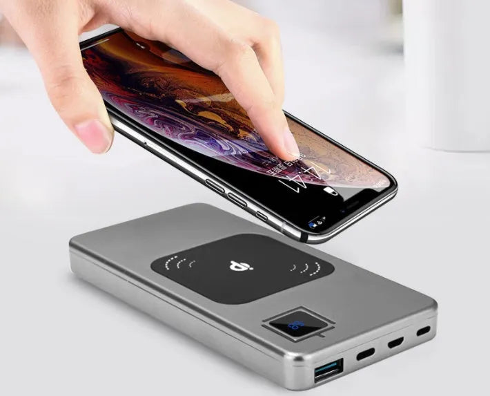 Silver alloy portable power bank with LCD screen showing battery percentage, alongside red and blue versions.
