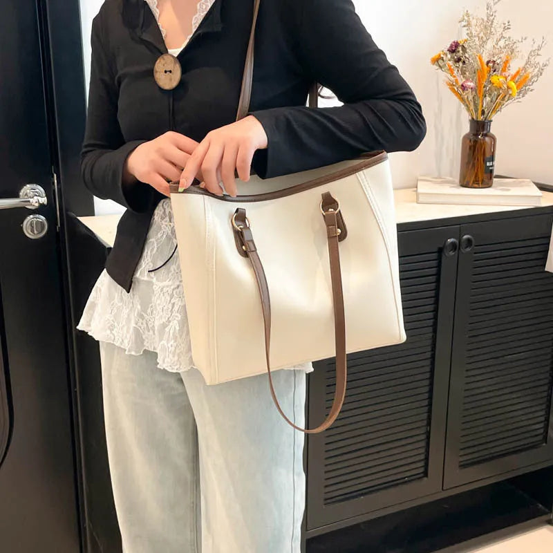 Large capacity PU tote bag in horizontal square shape with external slit pocket and internal organisation