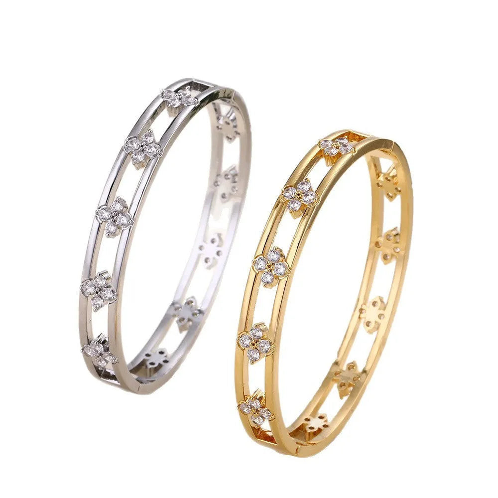 Gold and silver hollow women's bracelet with four-leaf clover design and zircon inlay.
