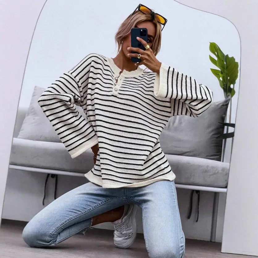 Black striped women's casual top with drop-shoulder sleeves on hanger
