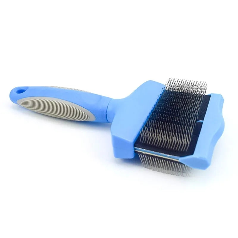 Blue double-sided pet brush with stainless steel pins next to a pink large version on a wooden surface.